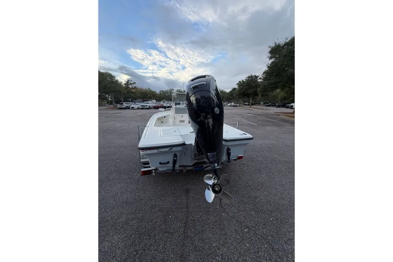 Slide: The Image of 2025 Mako 18 LTS boat with outboard motor in parking lot, rear view. - 8