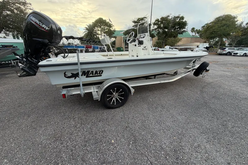 The Image of 2025 Mako 18 LTS boat on trailer with Mercury engine, parked outdoors. - 0