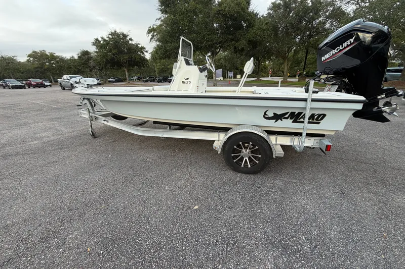 Slide: The Image of 2025 Mako 18 LTS boat on trailer in parking lot, featuring Mercury engine. - 1