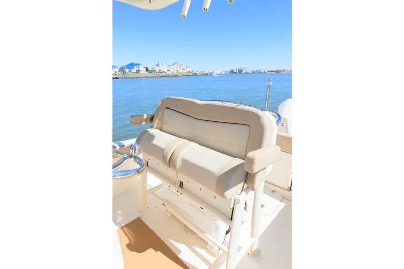Slide: The Image of 2024 Scout 240 XSF boat seating with ocean view in the background. - 9