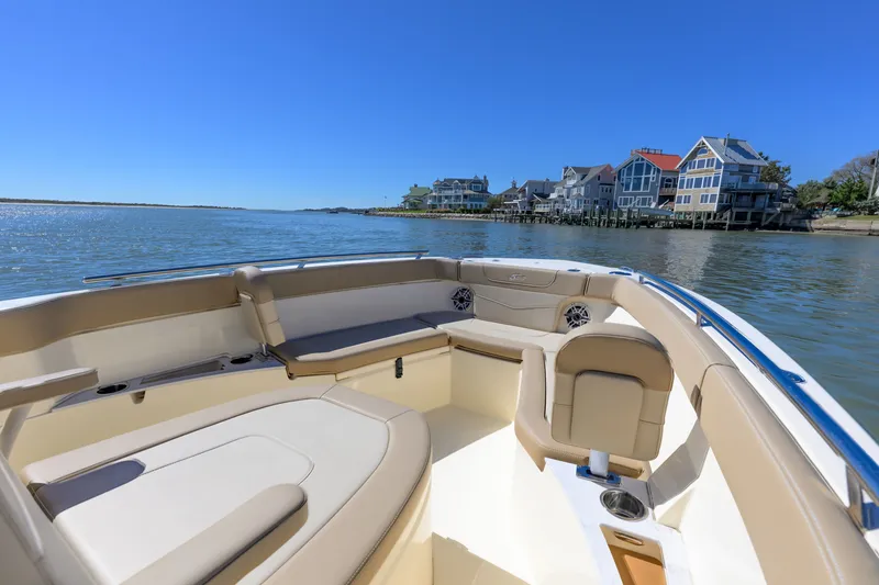 Slide: The Image of 2024 Scout 240 XSF boat interior with waterfront homes in the background. - 10