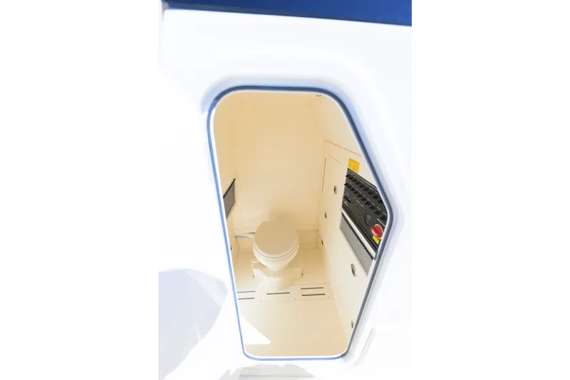 Slide: The Image of 2024 Scout 240 XSF boat interior with compact marine toilet and control panel. - 12
