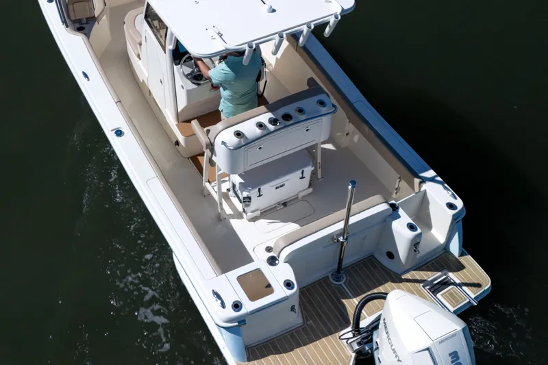 Slide: The Image of 2024 Scout 240 XSF boat on water, featuring spacious deck and modern design. - 3