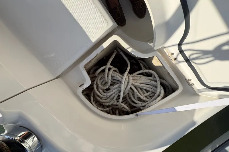 Slide: The Image of Storage compartment with coiled rope on a 2007 Hunter 41 Deck Salon boat. - 5