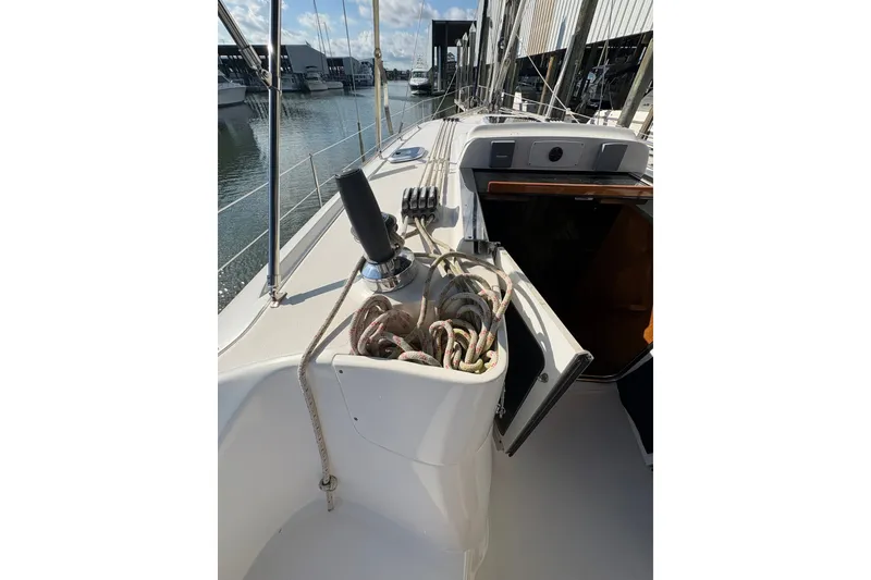 Slide: The Image of 2007 Hunter 41 Deck Salon sailboat deck with ropes and winch in marina. - 8