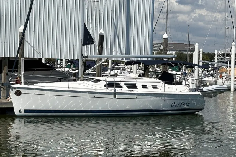 The Image of 2007 Hunter 41 Deck Salon sailboat docked at marina, featuring sleek design and spacious deck. - 0