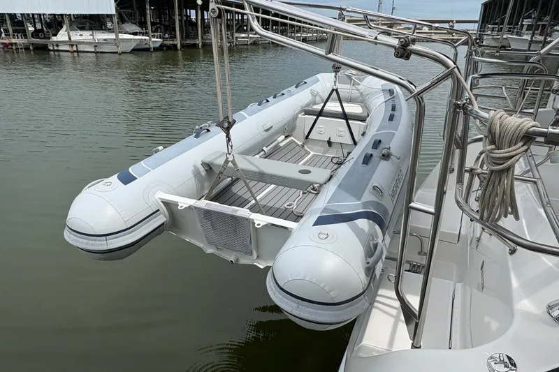 Slide: The Image of Inflatable dinghy suspended on a 2007 Hunter 41 Deck Salon yacht in a marina. - 31