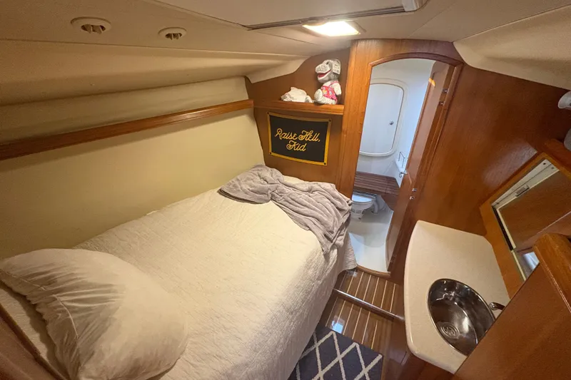 Slide: The Image of Cozy cabin interior of 2007 Hunter 41 Deck Salon with bed, sink, and bathroom. - 26