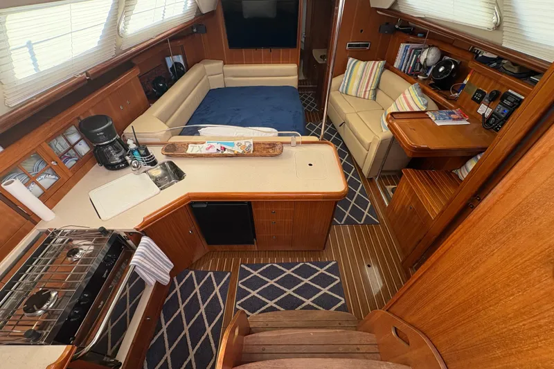 Slide: The Image of Interior of 2007 Hunter 41 Deck Salon yacht with cozy seating and modern amenities. - 7
