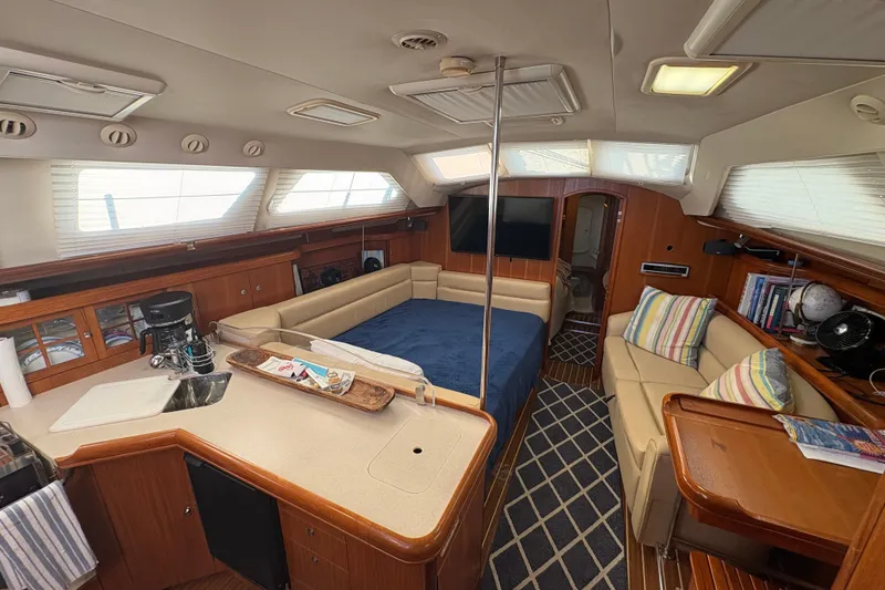 Slide: The Image of Interior of 2007 Hunter 41 Deck Salon yacht with cozy seating and modern amenities. - 16