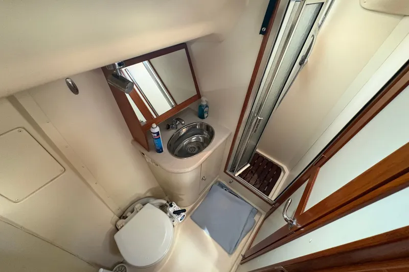 Slide: The Image of Bathroom interior of 2007 Hunter 41 Deck Salon yacht, featuring sink, toilet, and shower. - 19