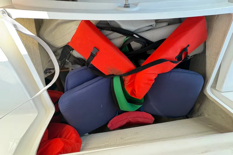 Slide: The Image of Storage compartment of 2007 Hunter 41 Deck Salon with life jackets and cushions. - 6