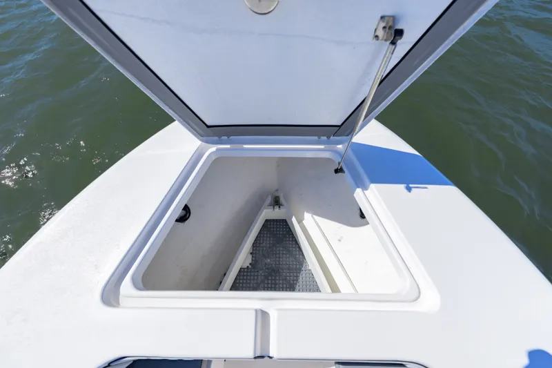 Slide: The Image of Open storage compartment on 2025 Delta Boatworks D245 boat, showing interior details. - 15