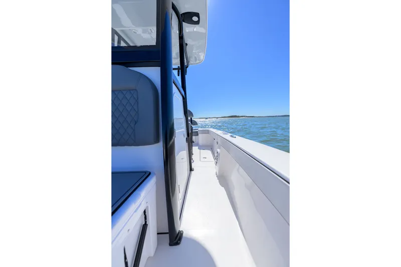 Slide: The Image of 2025 Delta Boatworks D245 cruising on open water under clear blue skies. - 16