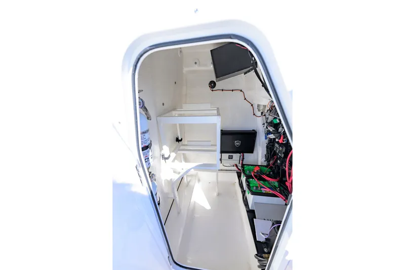 Slide: The Image of Interior view of 2025 Delta Boatworks D245, showcasing electronic equipment and wiring. - 18