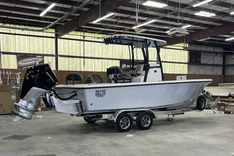 Slide: The Image of 2025 Delta Boatworks D245 in a warehouse, featuring a sleek design and powerful outboard motor. - 21