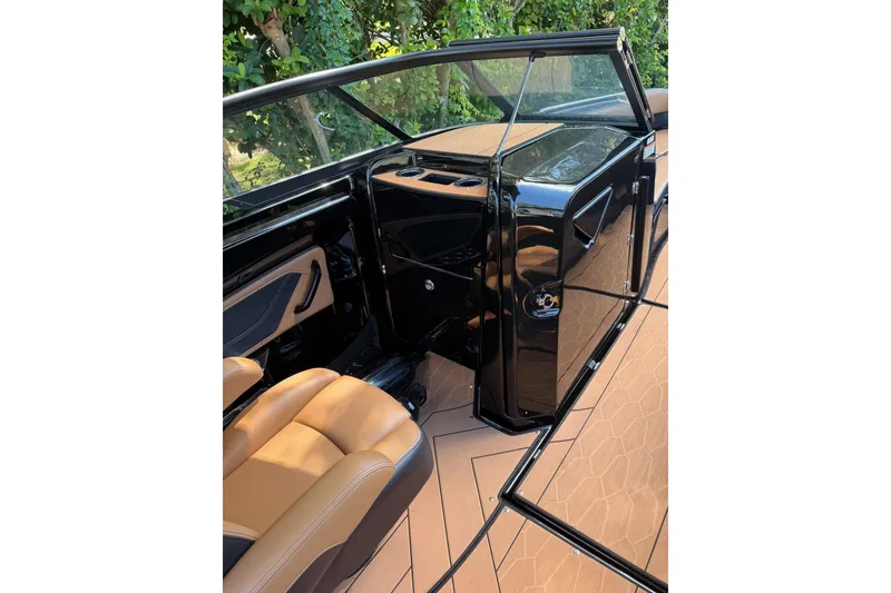 Slide: The Image of 2026 Ymaha 255 boat interior with sleek black and tan design, featuring modern seating. - 16