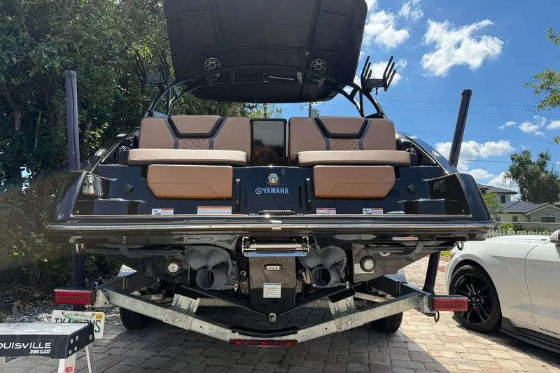 Slide: The Image of 2026 Ymaha 255 boat on trailer, rear view with seating and dual engines. - 4