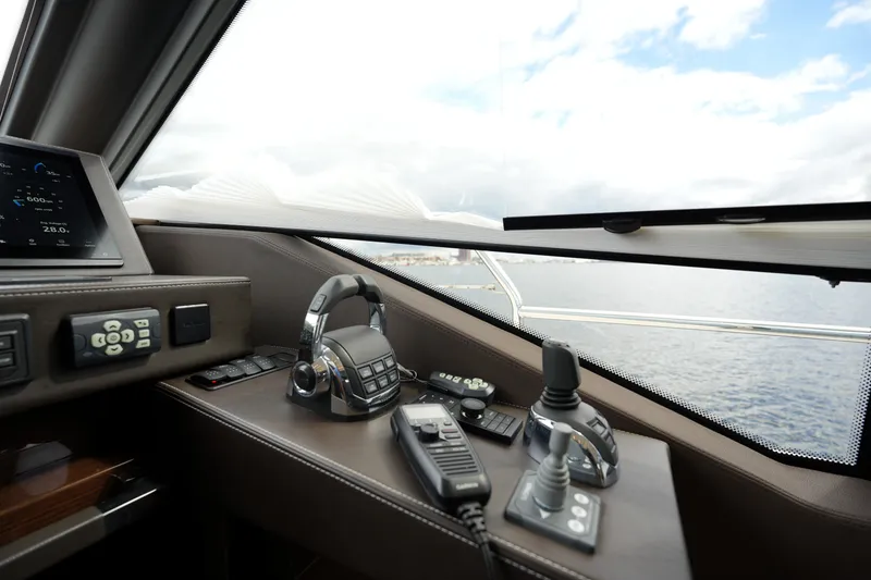 Slide: The Image of Control panel of 2023 Prestige 690 yacht with ocean view through window. - 83