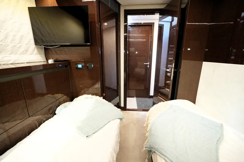 Slide: The Image of Luxurious 2023 Prestige 690 yacht cabin with twin beds and modern amenities. - 117