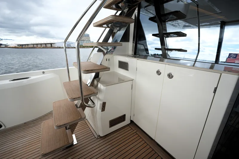 Slide: The Image of Staircase on 2023 Prestige 690 yacht with wooden steps and sleek design. - 24
