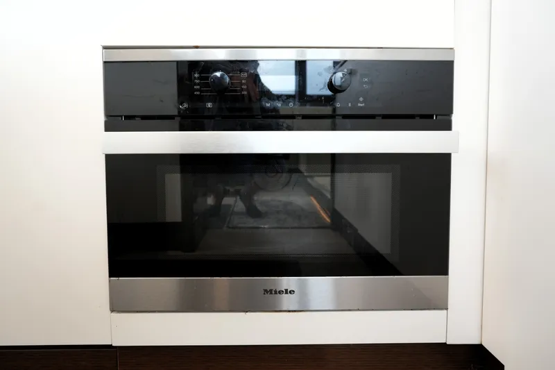 Slide: The Image of Modern built-in oven with sleek black and stainless steel design, Prestige 690, 2023 model. - 60