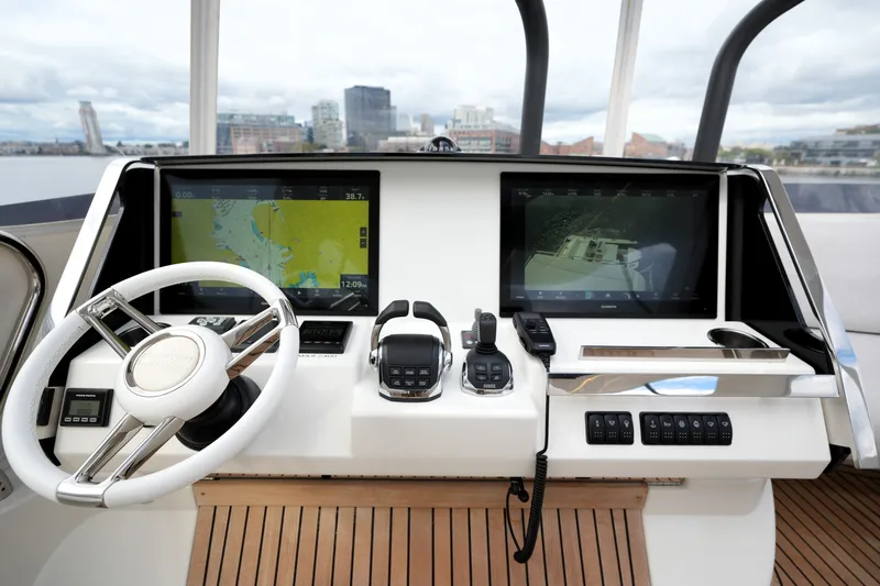 Slide: The Image of Cockpit of 2023 Prestige 690 yacht with dual navigation screens and modern controls. - 45