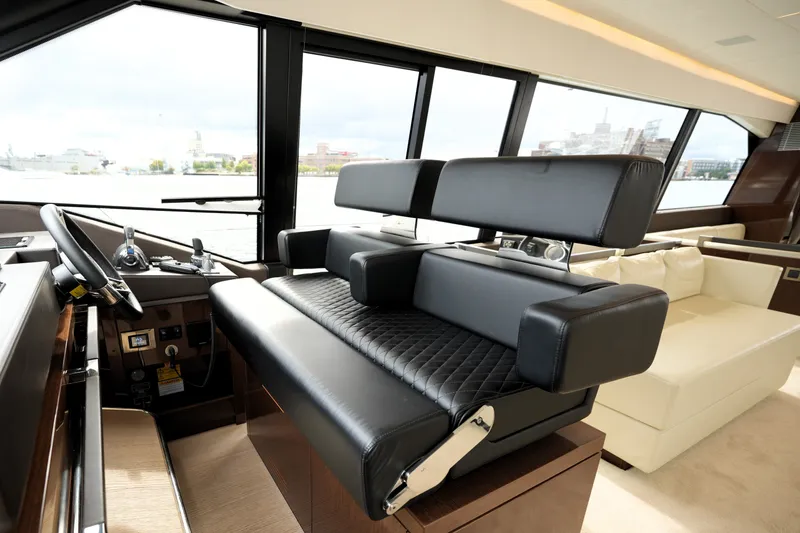 Slide: The Image of Luxurious interior of 2023 Prestige 690 yacht with modern helm and seating. - 77