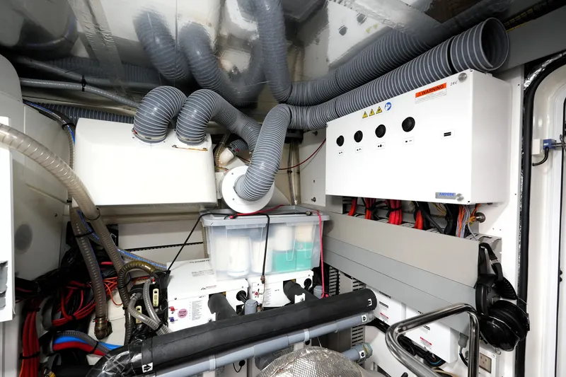 Slide: The Image of Engine room of 2023 Prestige 690 yacht with complex wiring and ventilation systems. - 130