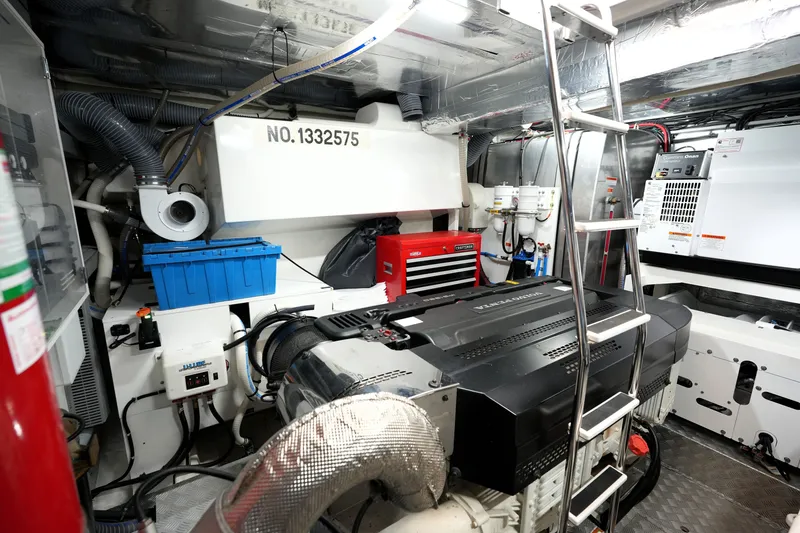 Slide: The Image of Engine room of 2023 Prestige 690 yacht with modern equipment and ladder access. - 126