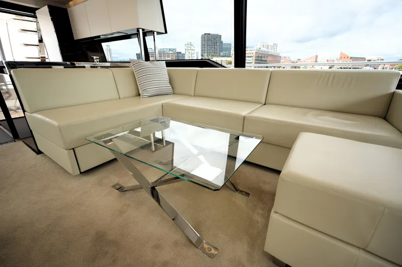 Slide: The Image of Luxurious interior of 2023 Prestige 690 yacht with beige leather seating and glass table. - 67