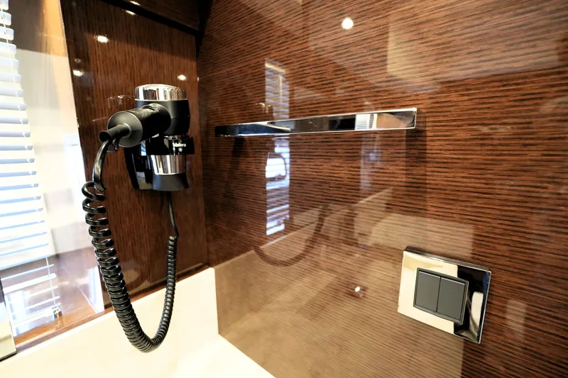 Slide: The Image of Luxury bathroom detail in 2023 Prestige 690 yacht, featuring modern fixtures and wood paneling. - 100