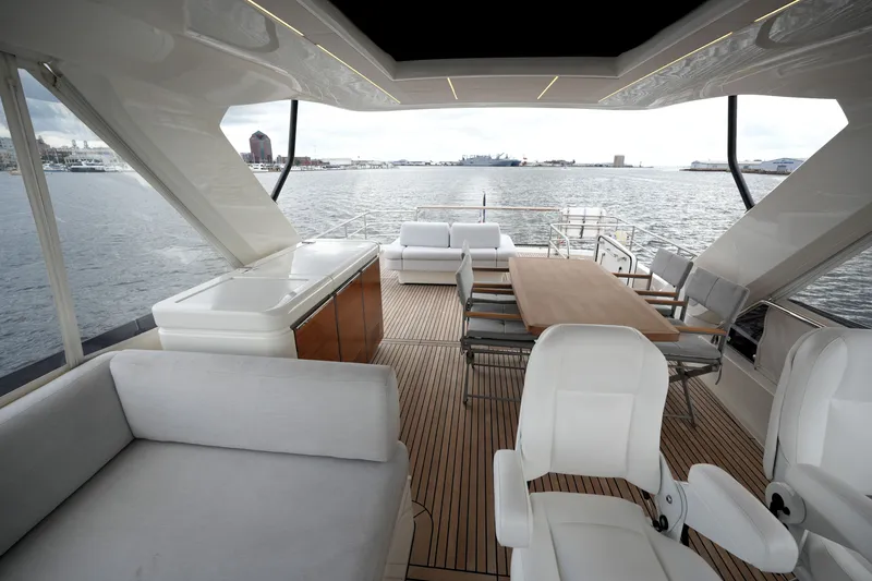Slide: The Image of Luxurious 2023 Prestige 690 yacht interior with elegant seating and ocean view. - 32