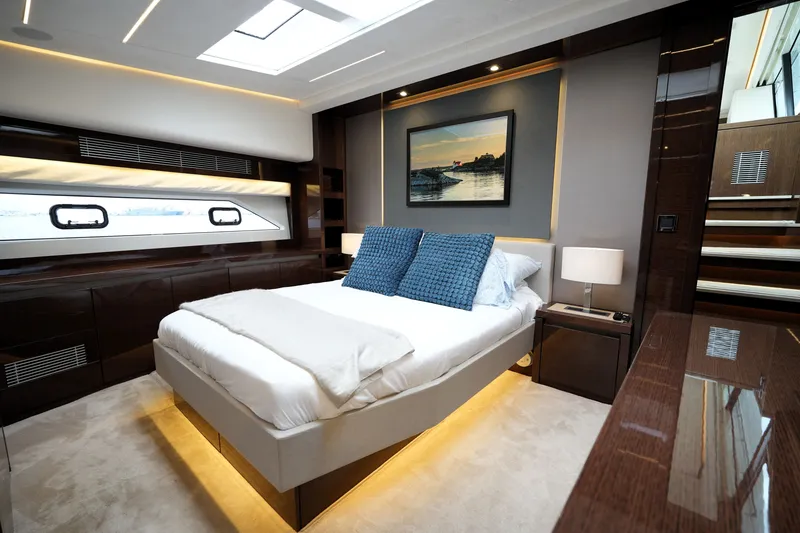 Slide: The Image of Luxurious bedroom interior of 2023 Prestige 690 yacht with modern design and elegant lighting. - 1