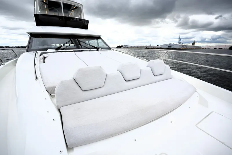 Slide: The Image of Luxurious 2023 Prestige 690 yacht with sleek design and spacious deck under cloudy skies. - 28