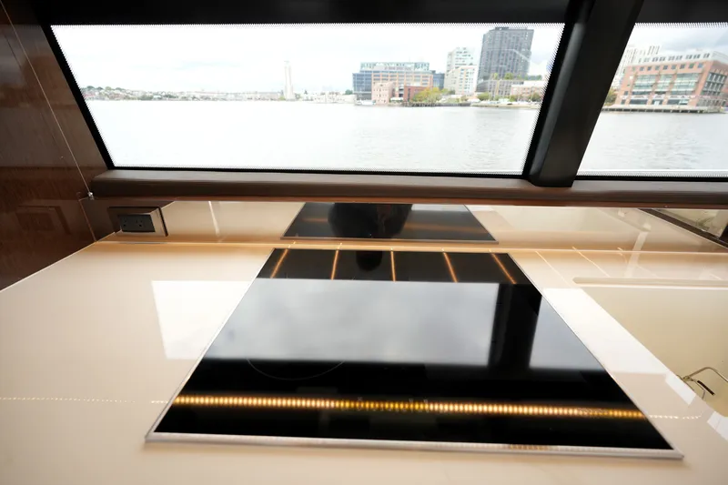 Slide: The Image of Modern kitchen interior on 2023 Prestige 690 yacht with waterfront view. - 59