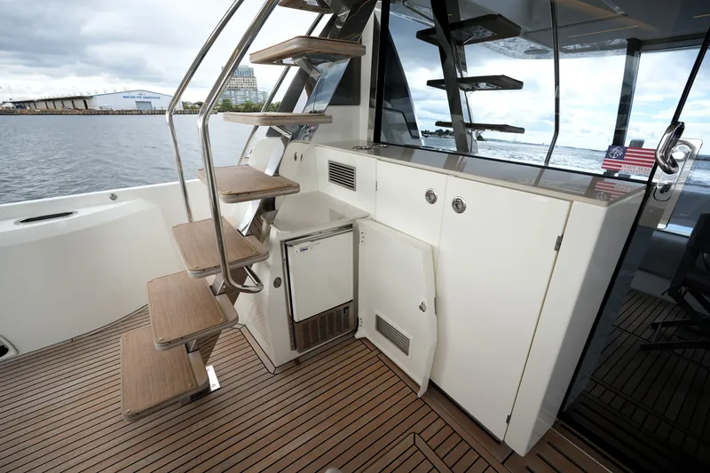 Slide: The Image of Modern 2023 Prestige 690 yacht interior with wooden stairs and sleek cabinetry. - 25