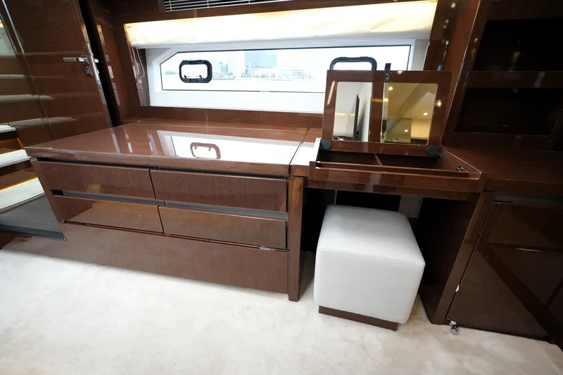 Slide: The Image of Luxurious interior of 2023 Prestige 690 yacht with elegant wood finish and vanity area. - 95