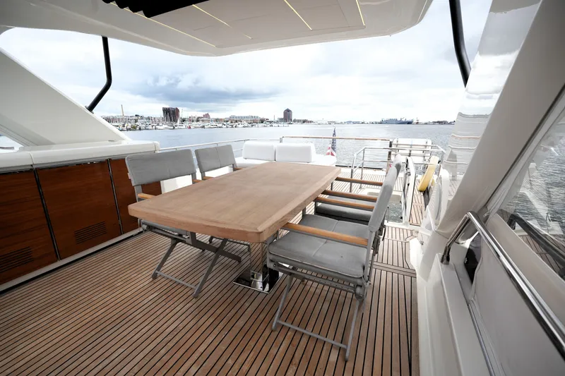 Slide: The Image of Luxurious 2023 Prestige 690 yacht deck with elegant dining area overlooking the water. - 37