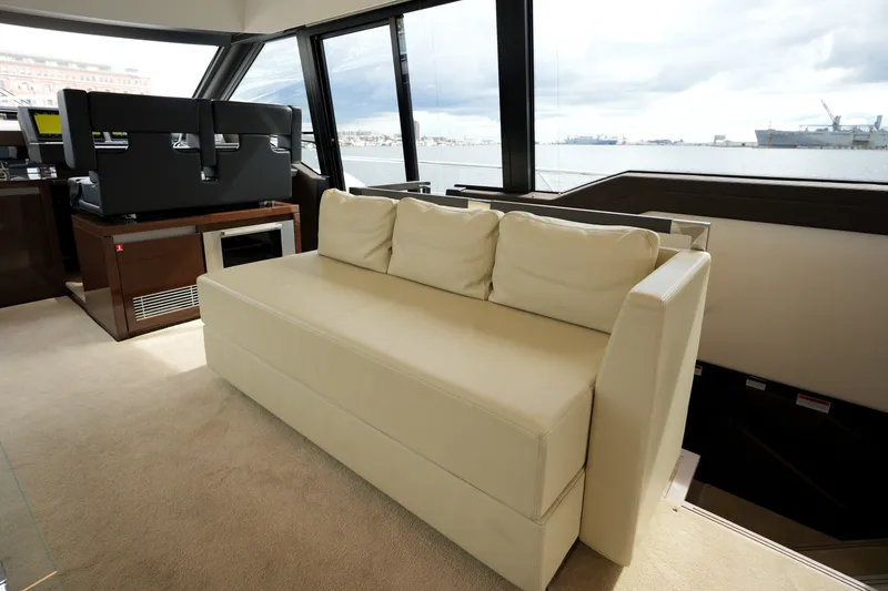Slide: The Image of Luxurious interior of 2023 Prestige 690 yacht with cream sofa and panoramic windows. - 69