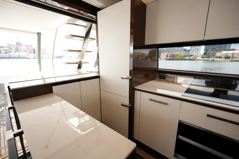 Slide: The Image of Modern kitchen interior on 2023 Prestige 690 yacht with sleek cabinetry and waterfront view. - 57