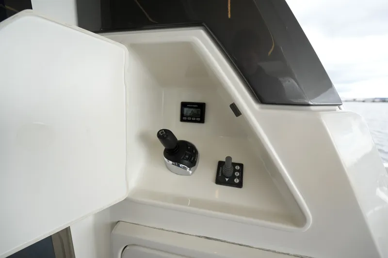 Slide: The Image of Control panel of 2023 Prestige 690 yacht, featuring joystick and display screen. - 22