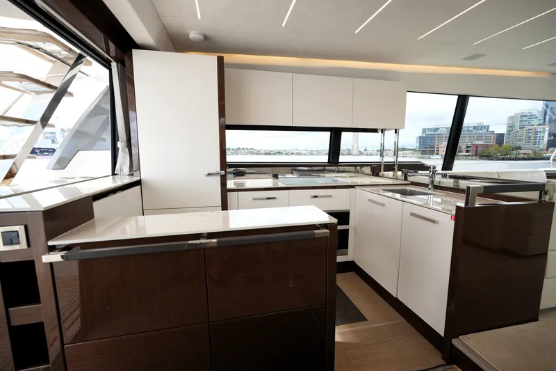 Slide: The Image of Luxurious kitchen interior of 2023 Prestige 690 yacht with modern cabinetry and waterfront view. - 52
