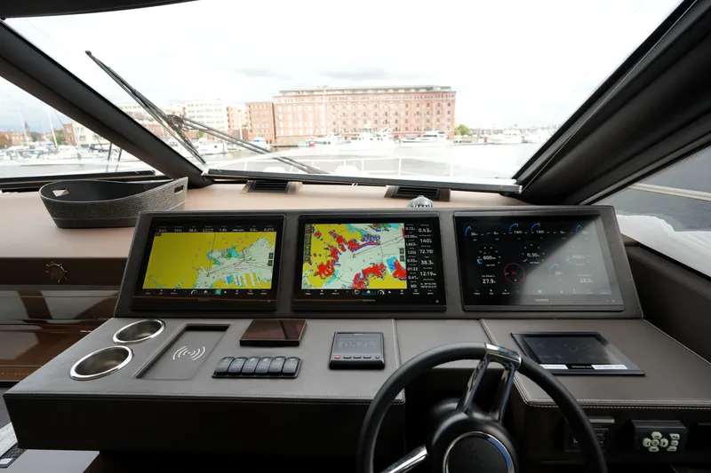 Slide: The Image of Cockpit of 2023 Prestige 690 yacht with advanced navigation displays and controls. - 80