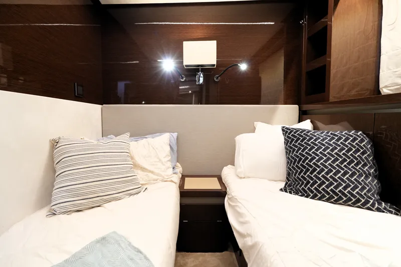 Slide: The Image of Luxurious twin cabin interior of 2023 Prestige 690 yacht with elegant bedding. - 116