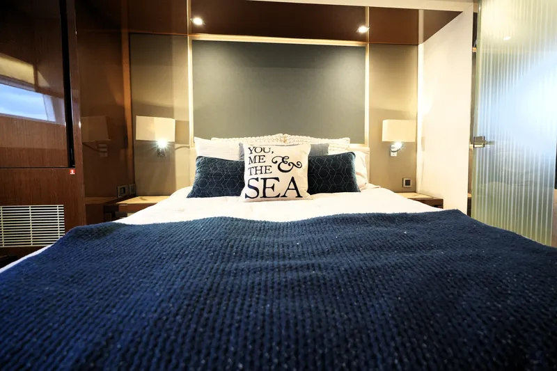 Slide: The Image of Luxurious bedroom interior on 2023 Prestige 690 yacht, featuring nautical-themed decor. - 106