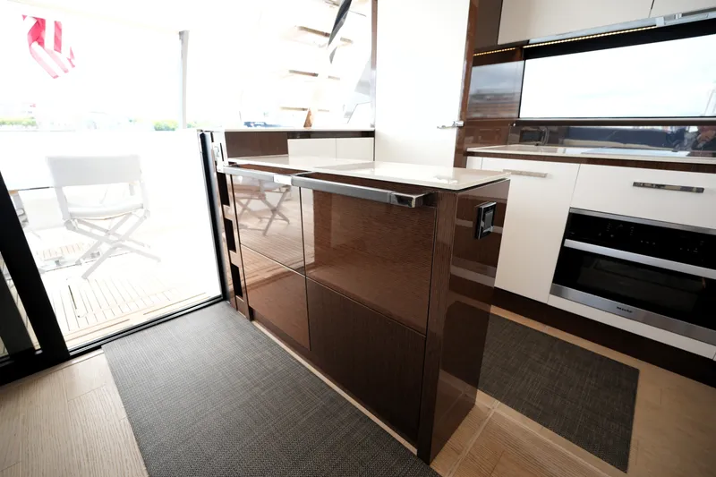 Slide: The Image of Modern kitchen interior on 2023 Prestige 690 yacht, featuring sleek cabinetry and appliances. - 54