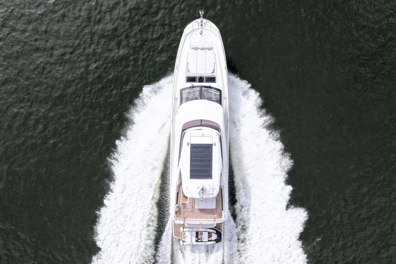 Slide: The Image of Aerial view of 2023 Prestige 690 yacht cruising on open water. - 9