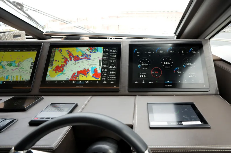Slide: The Image of Cockpit of 2023 Prestige 690 yacht with advanced Garmin navigation displays. - 82
