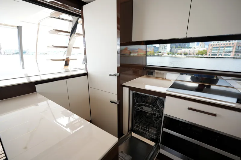 Slide: The Image of Modern kitchen interior on 2023 Prestige 690 yacht with sleek cabinetry and waterfront view. - 58